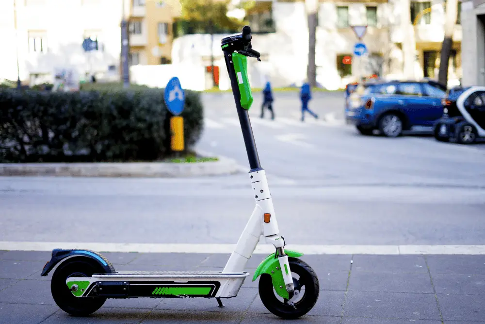 An electric scooter standing on a road side 