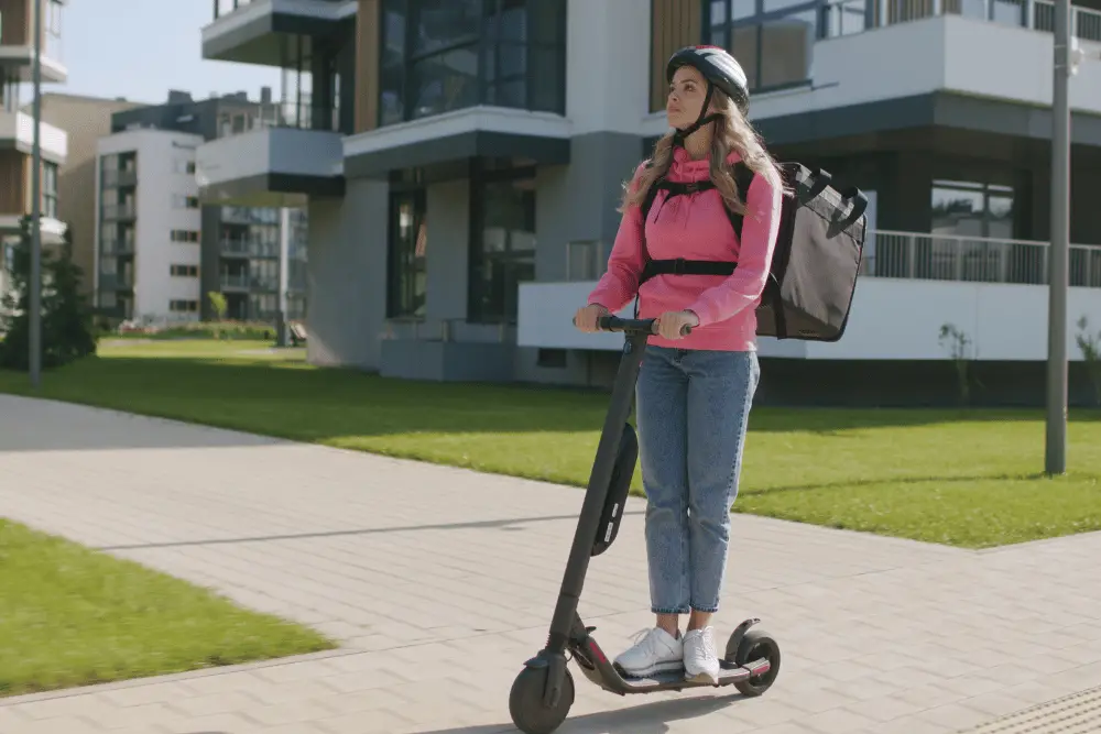 A delivery girl on an electric scooter