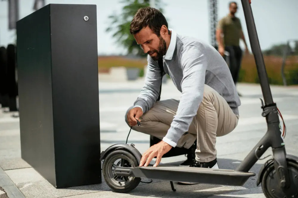 A man charging an electric scooter