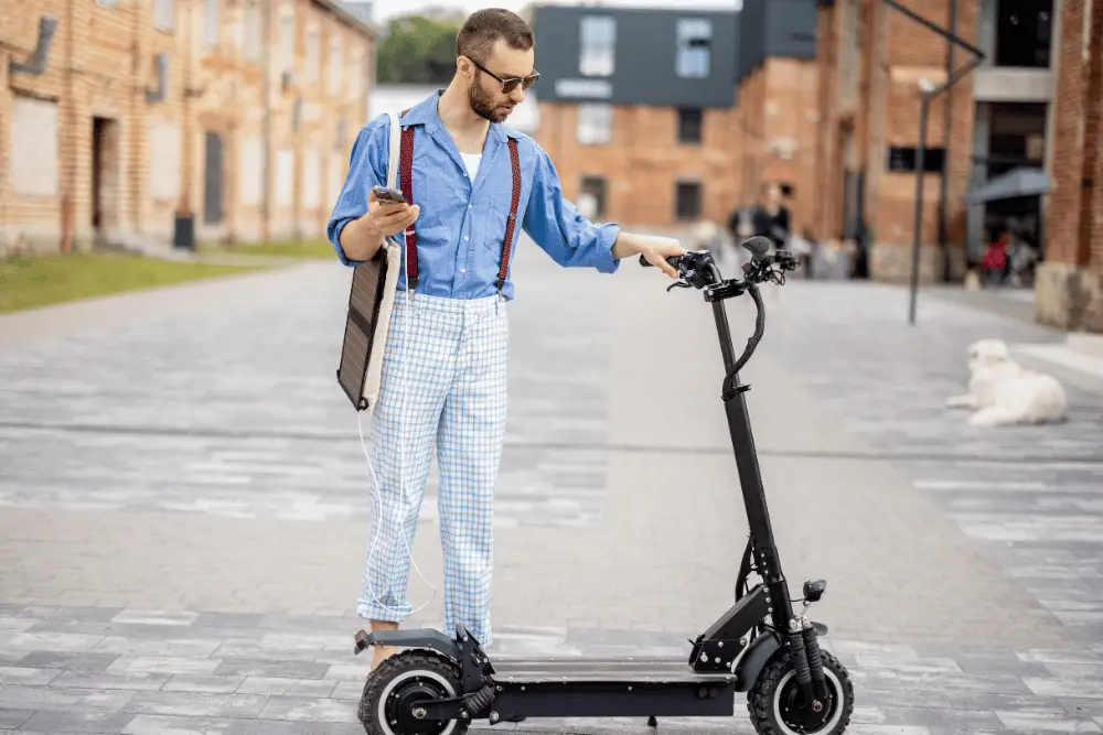 A young guy with blue shirt and strips pant with black stylish electric scooter
