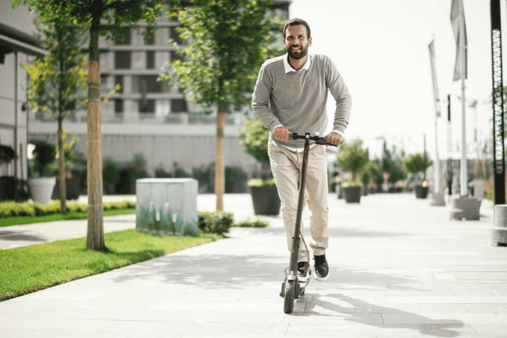 A man ridding an electric scooter